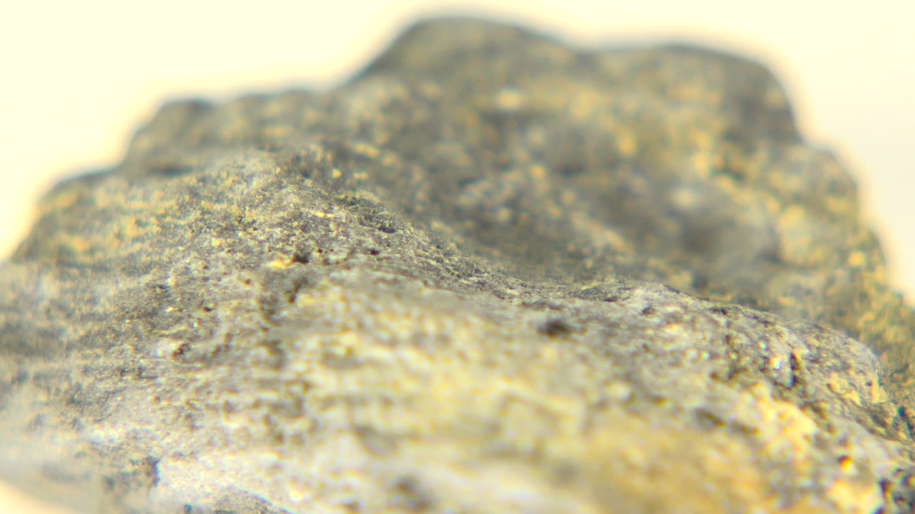 A close view of the golden-looking rock fills the Westminster frame, with the central ridge sharper than the blurred foreground and no visible people.