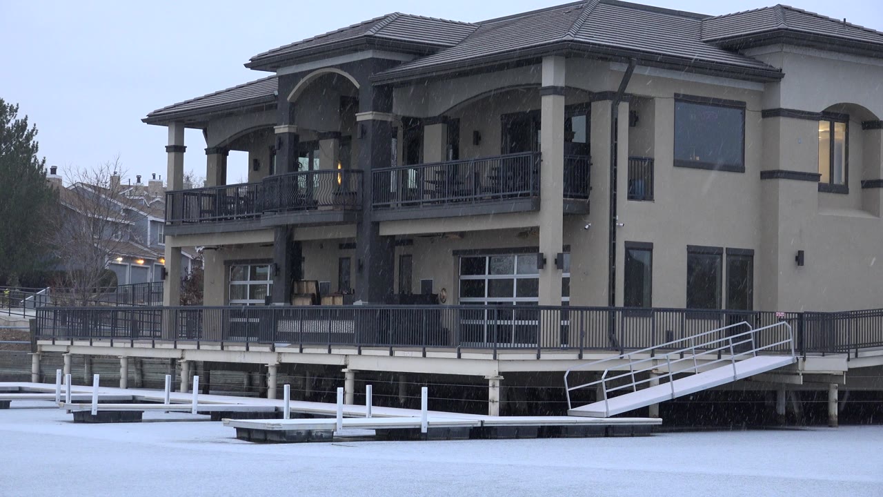 The Westminster house remains centered with its upper balcony, dark trim, white dock rails, pale winter sky, and no visible people.