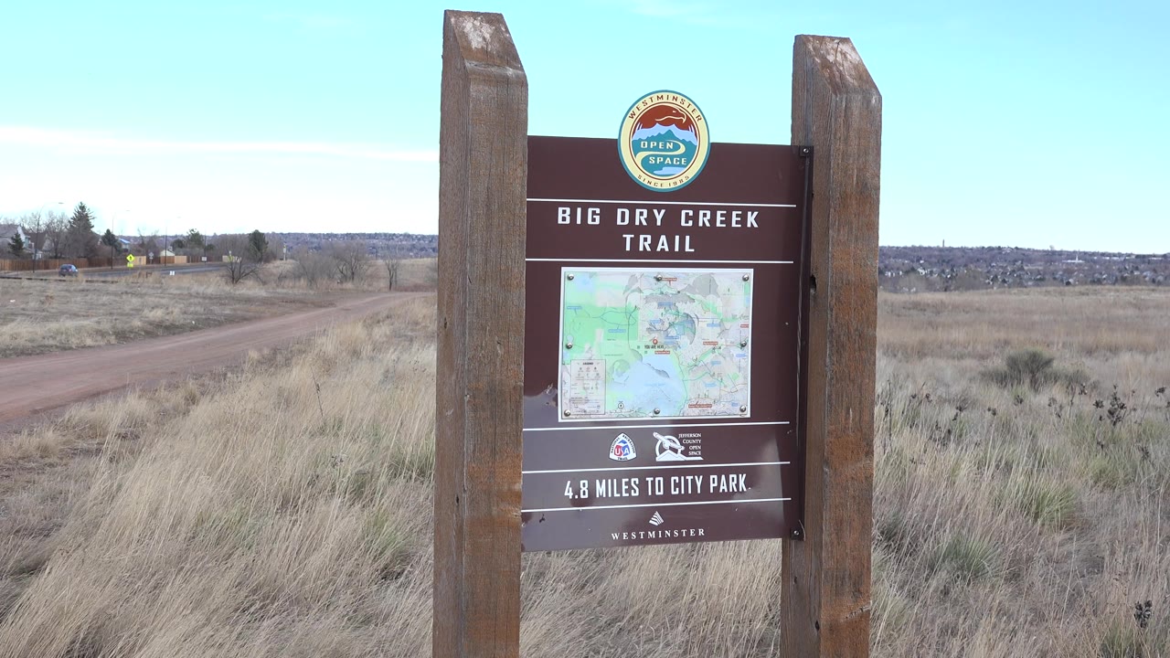 Big Dry Creek Trail sign with dry field stretching behind it
