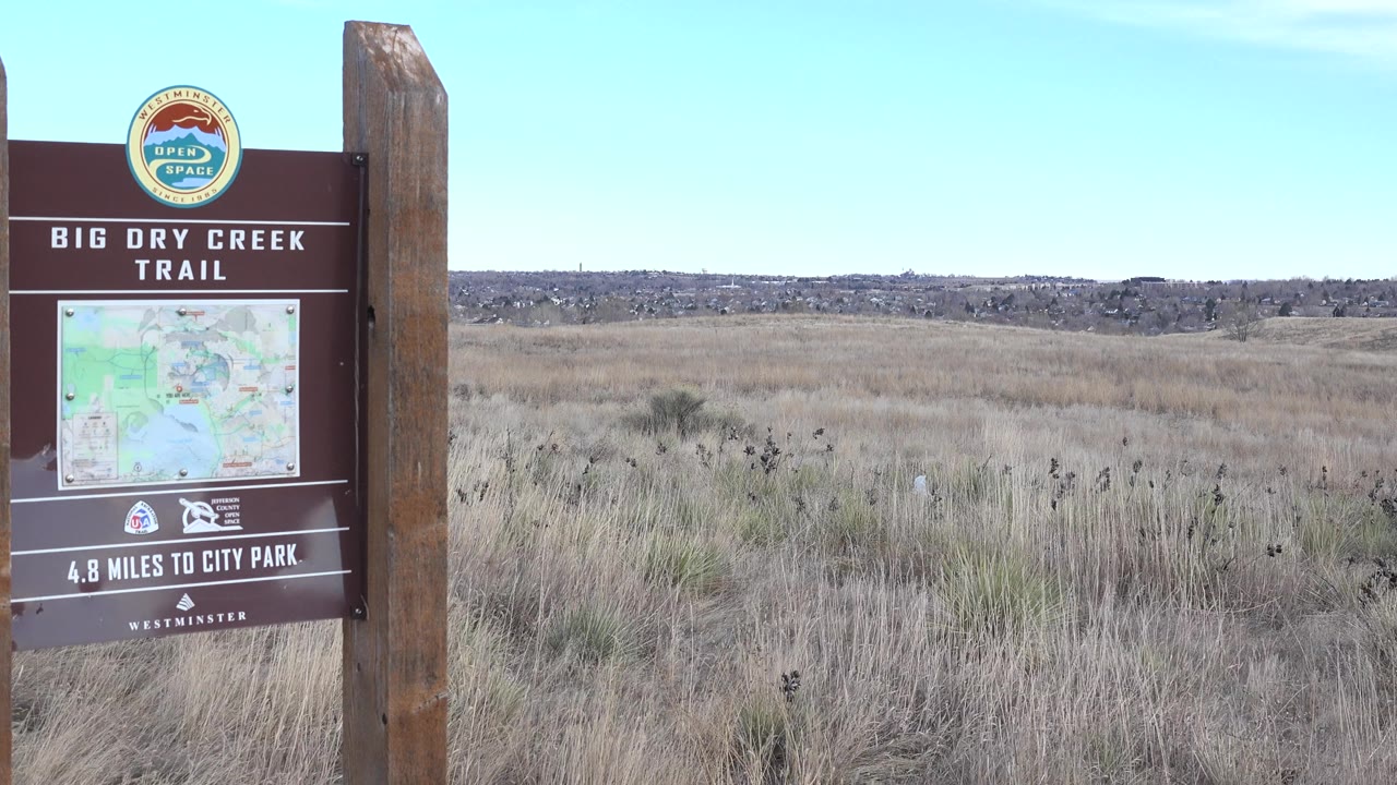 Big Dry Creek Trail sign near center-left in a wide field view.