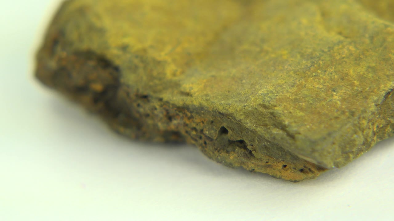 Flat green rock top with darker porous rim