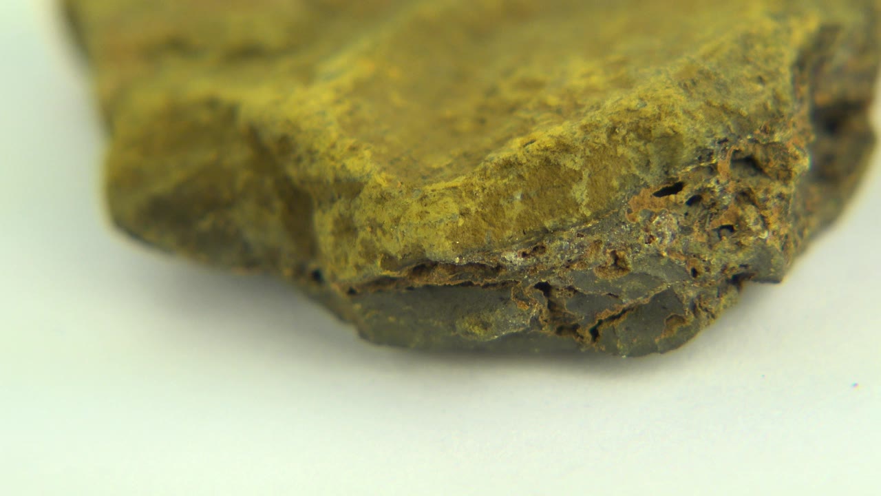 At 0:00, the Westminster, Colorado clip shows the rough front edge of a brownish yellow rock on a pale tabletop with no visible people.