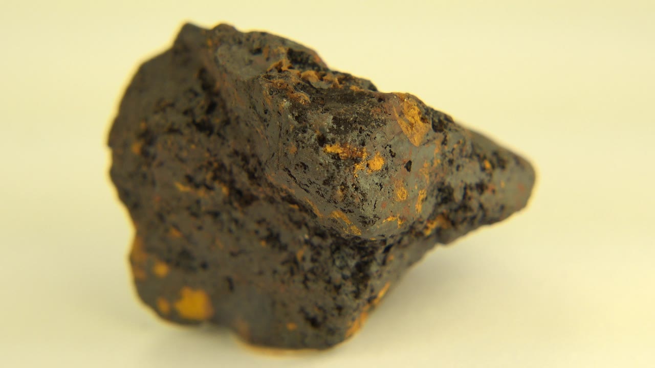 Rotated brown rock with pointed end facing right.