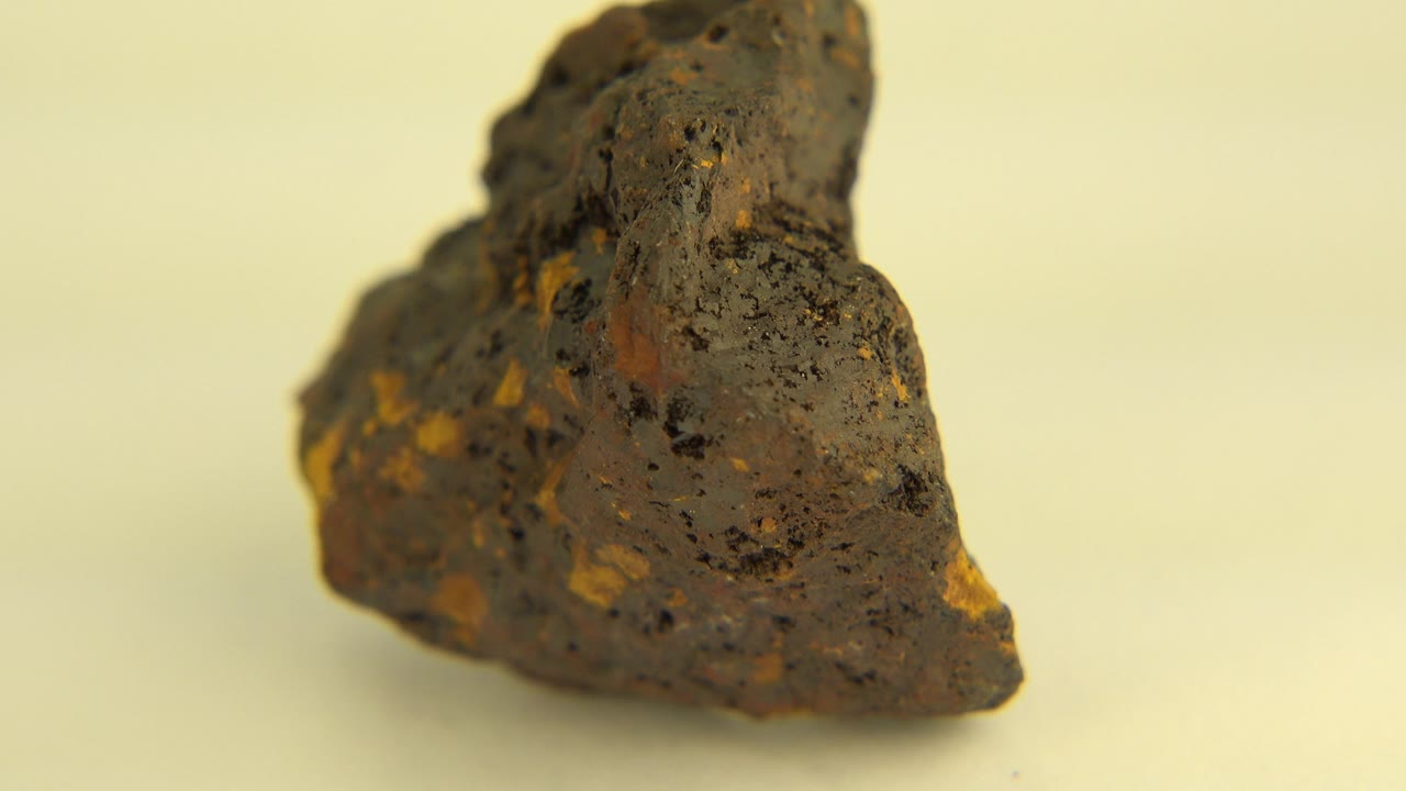 Jagged dark rock turned to show a lower rounded side.