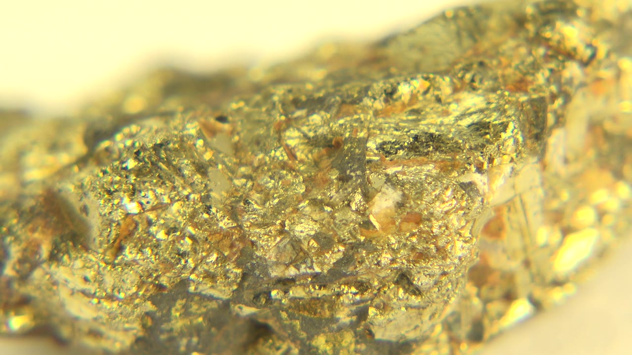 Gold crystal rock with bright highlights and rough texture