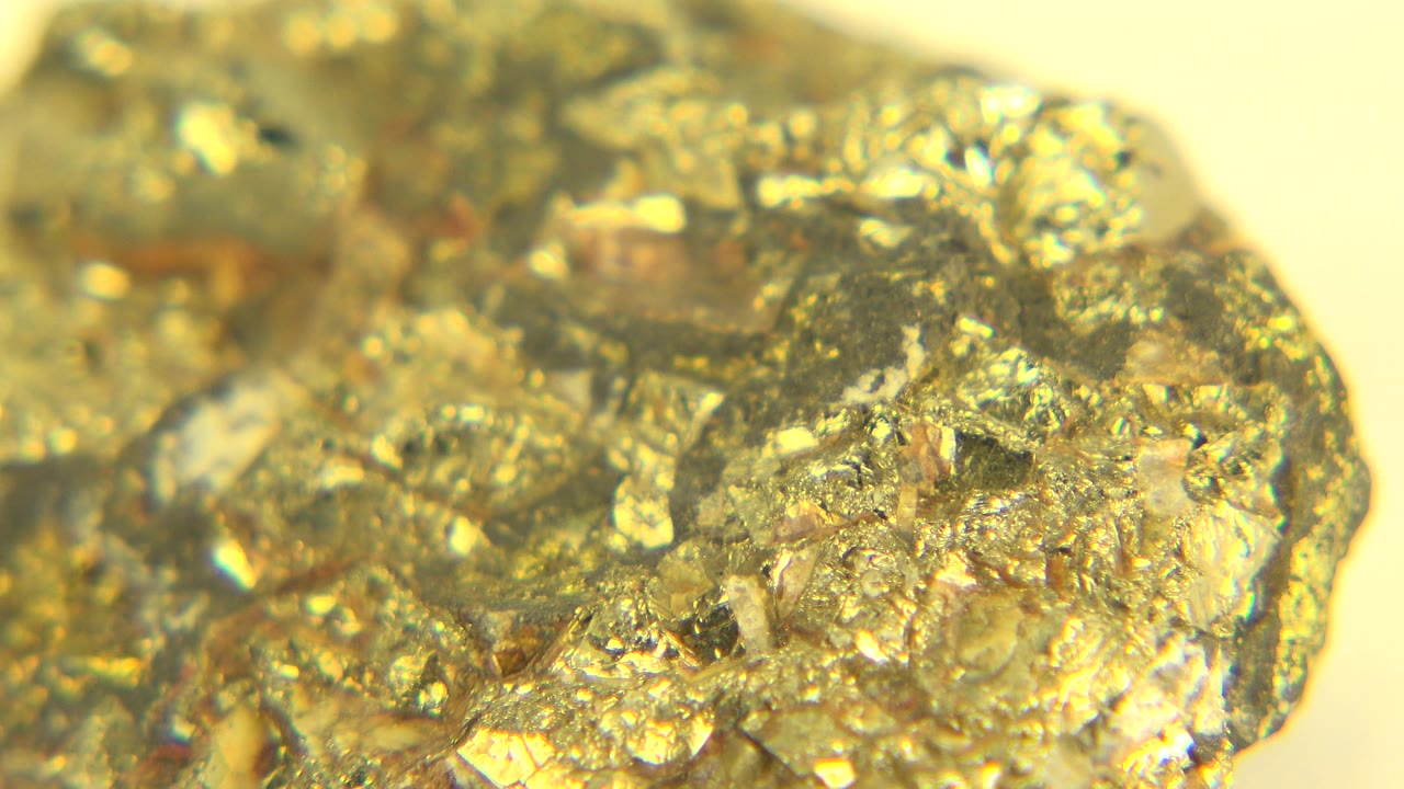 Sparkling rock edge against a pale yellow background.