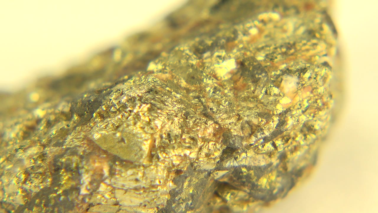 Close macro frame from Westminster, Colorado showing the stone's angular gold surface and small bright highlights, with no visible people.