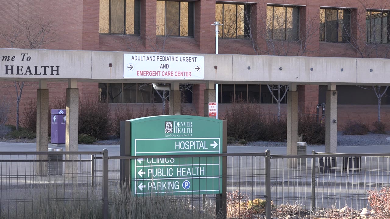 Denver Health sign before a medical building entrance
