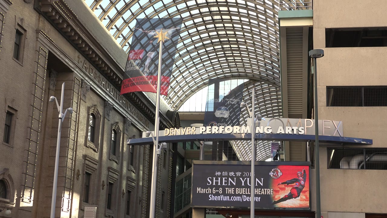 Second frame holds on the glass canopy and side architecture in Westminster, Colorado, with a Shen Yun advertisement visible and no visible people.