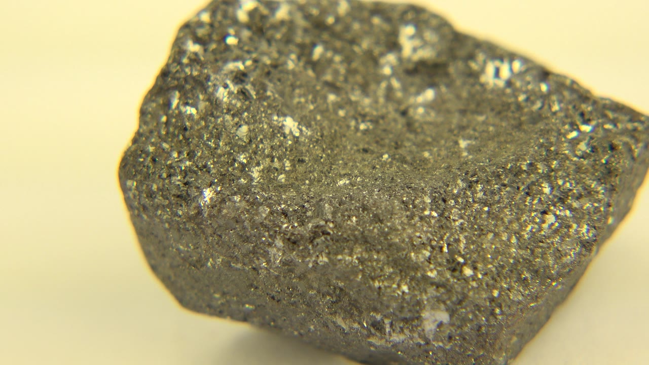 Angled close-up of a gray rock with sparkling inclusions.