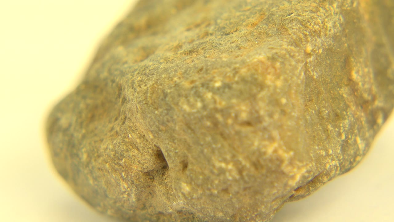 Close-up stone rotated to show a sloped right edge and rough top surface.
