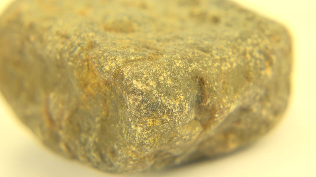 The rock-like object appears slightly turned in the frame, showing a rounded top surface and dark side markings in the Westminster, Colorado footage with no visible people.