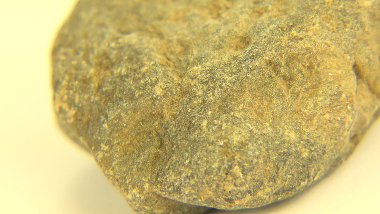 Rounded pebble edge on yellow background.