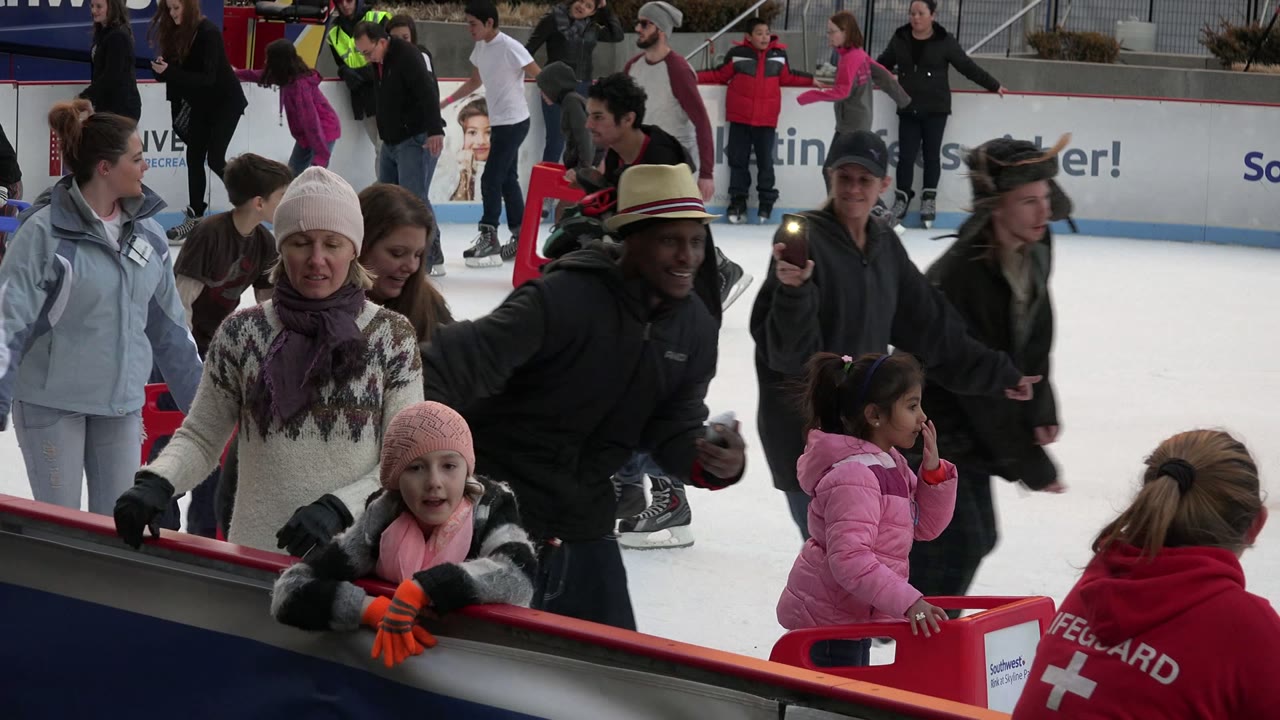 The second frame shows a child in pink at the barrier, an adult in a patterned sweater, an adult in a dark jacket, and several skaters moving across the Westminster rink background.
