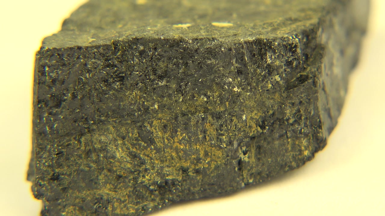A similar close view shows the rock's squared edge and mottled dark surface in the Westminster, Colorado clip, with no visible people.