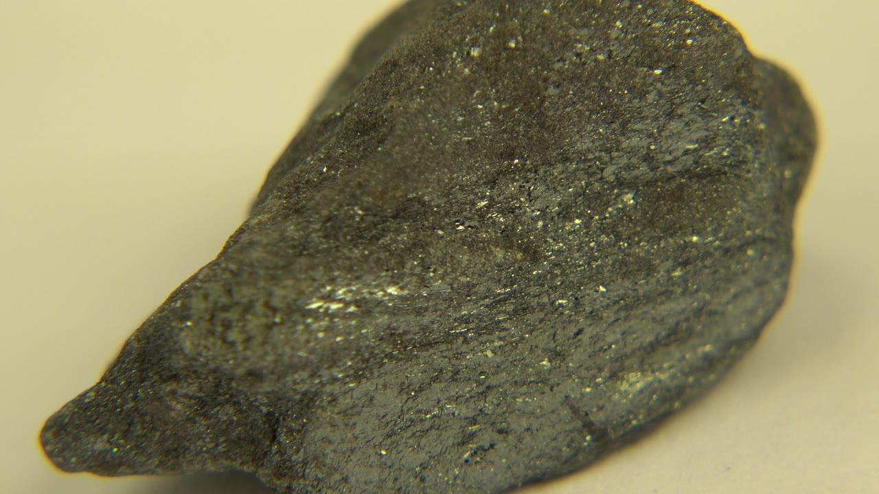 Pointed side of dark rock on tabletop