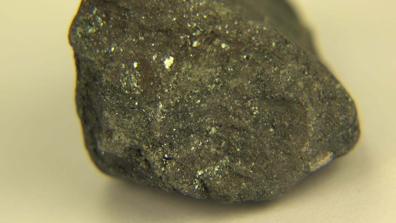 Glittering rock turned to show rounded face