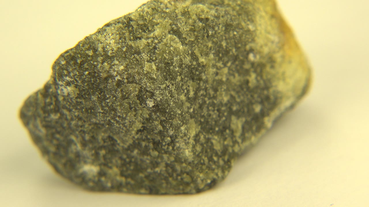 Dark rock turned to show a longer side