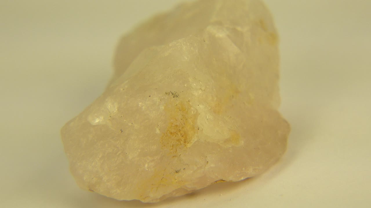 The stone remains centered in a tight Westminster, Colorado close-up, showing cloudy yellow facets, amber marks, and no visible people.