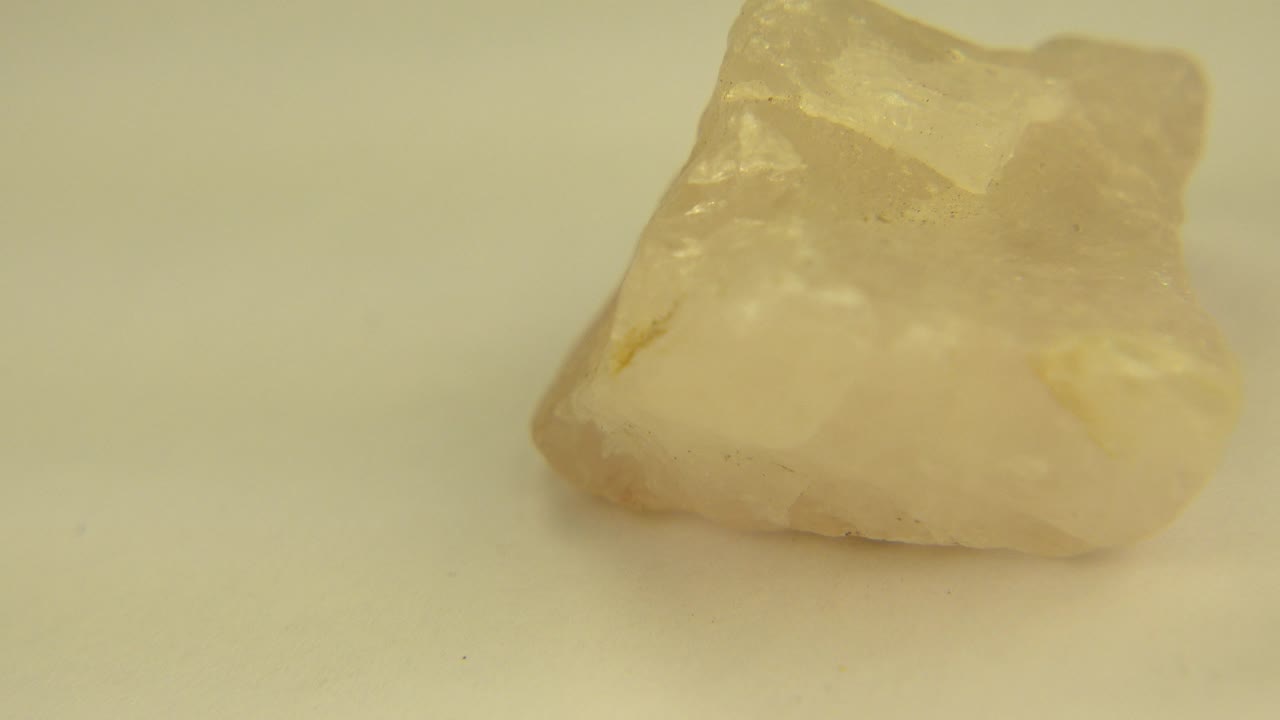 Jagged pale rock angled on a white surface
