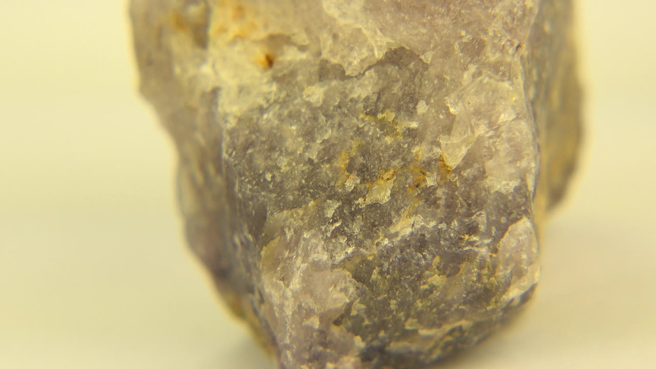 Angled rock close-up on pale yellow floor