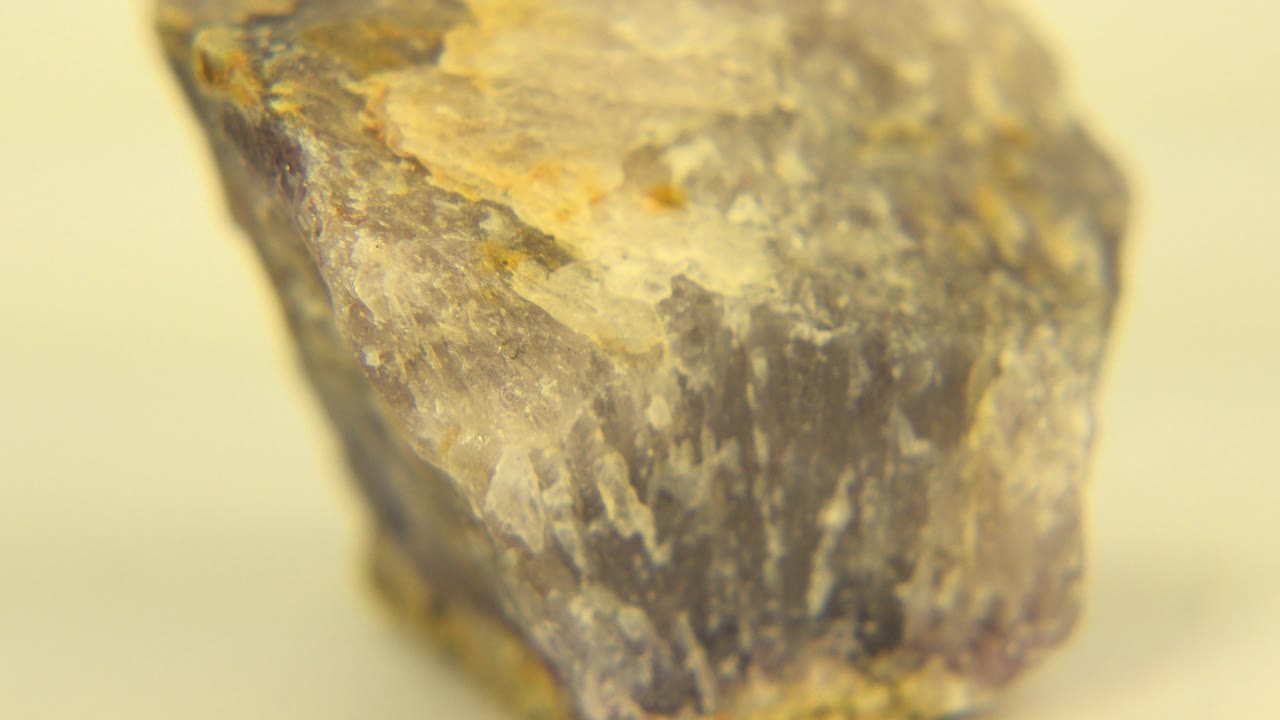 Macro-style rock close-up with a brighter chipped top surface.