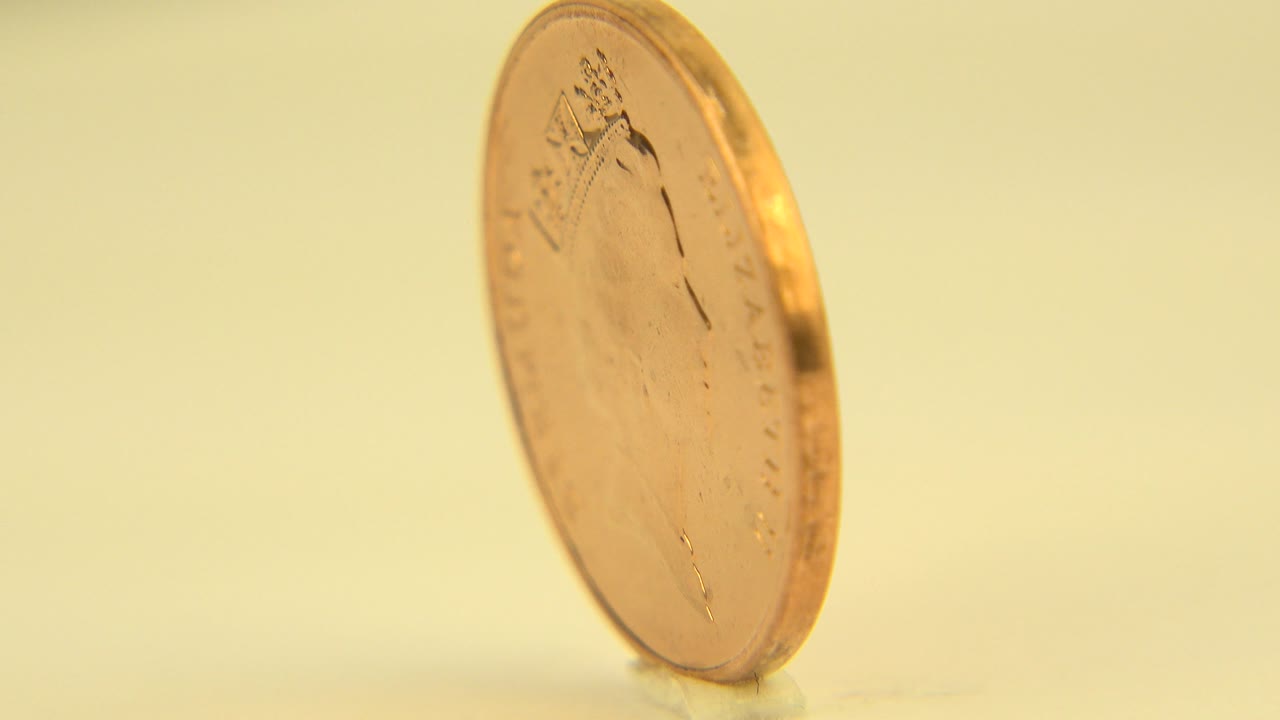 Bermuda penny viewed from a narrow edge angle.