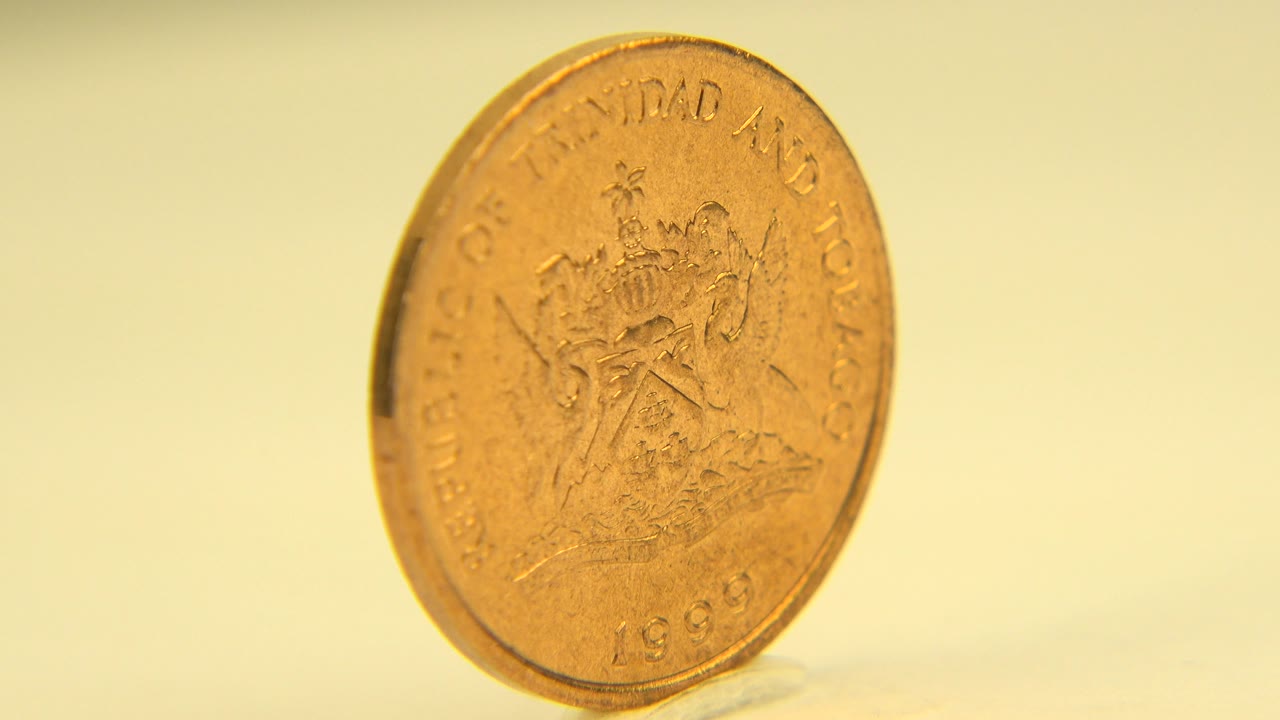 The upright coin remains near the center of the Westminster, Colorado frame, tilted slightly with its engraved face still visible and no visible people.