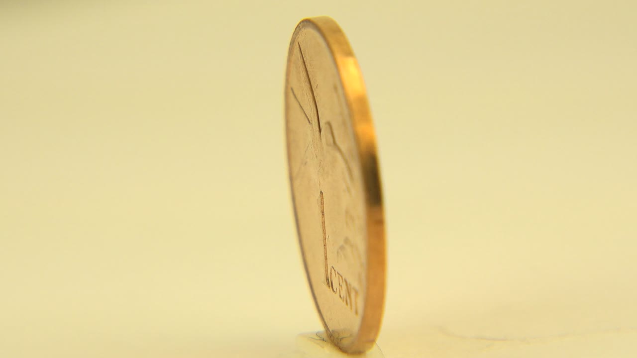 Thin rim of a gold coin on a tabletop