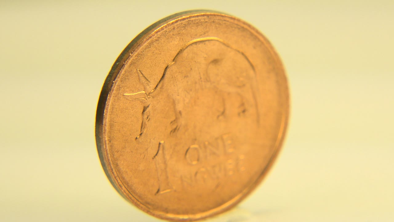 One-cent coin tilted with more of its face visible.