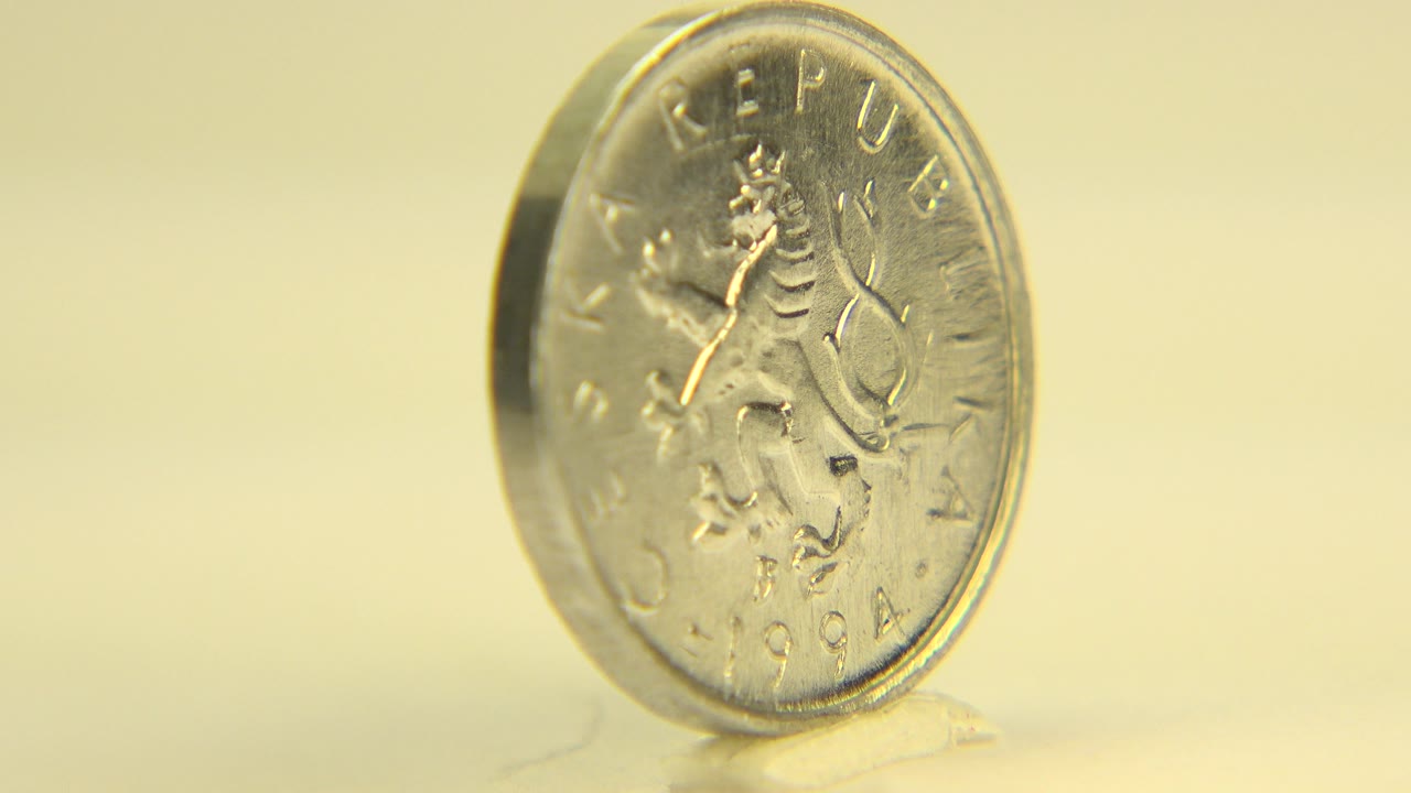 The coin stays slightly angled in a tight Westminster, Colorado macro frame, with the Czech Republic lettering softened by shallow focus and no visible people.