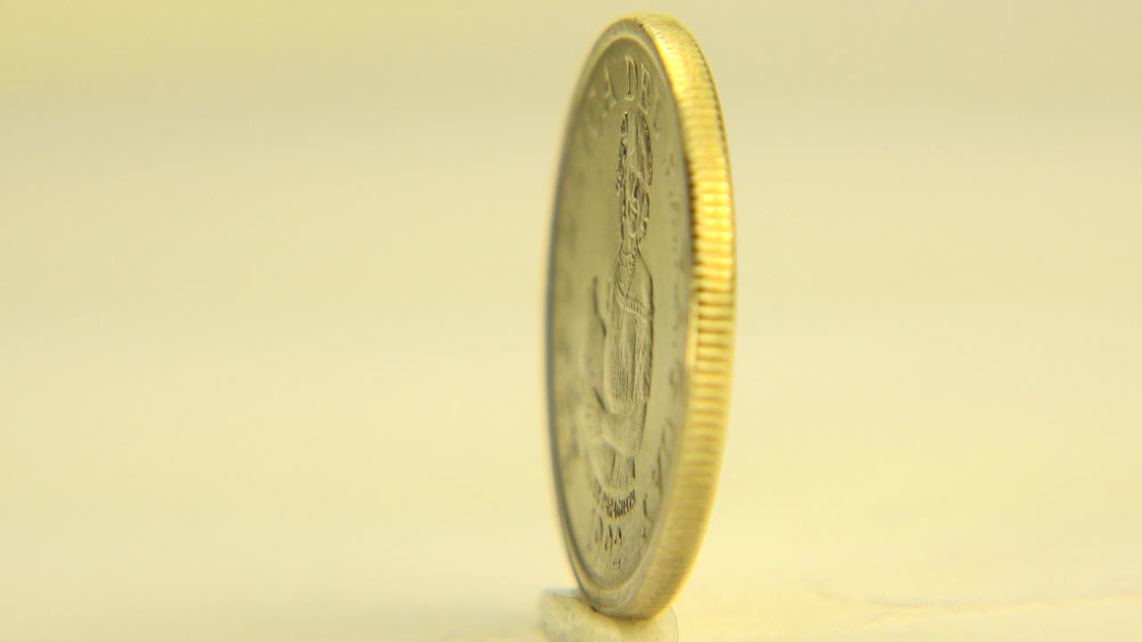 Gold coin turned to a narrow side angle.
