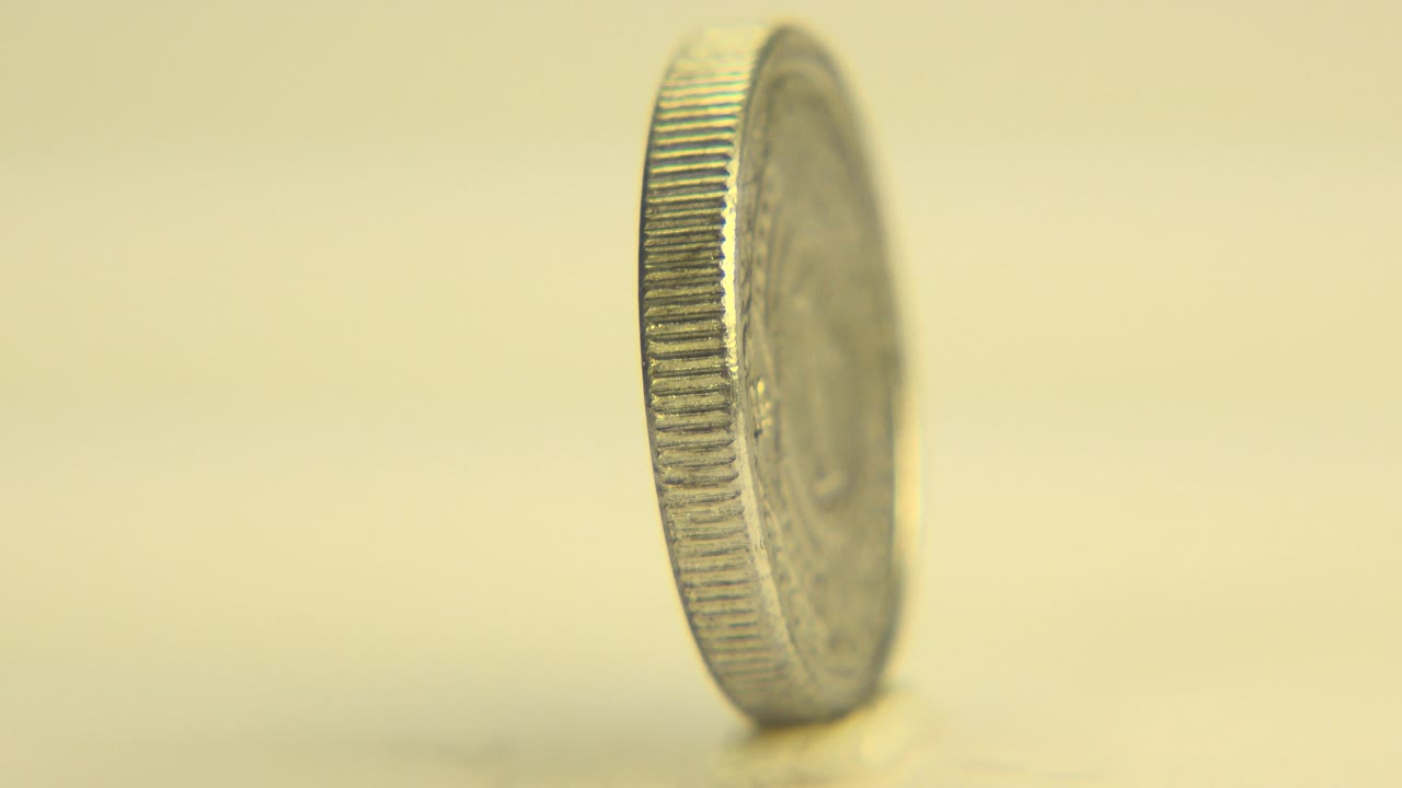 Upright coin angled on tabletop with partial face visible