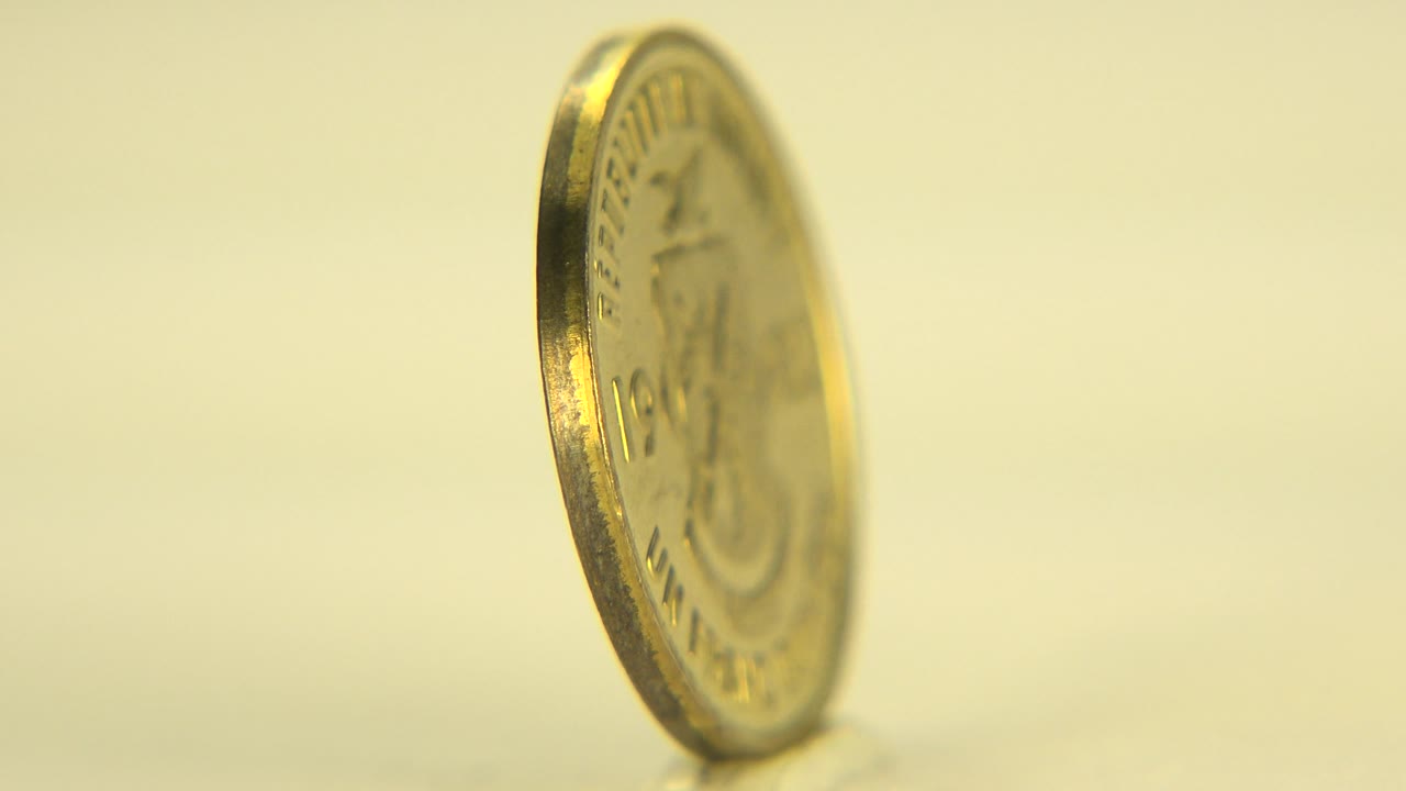 Gold-colored coin partly turned toward the camera.