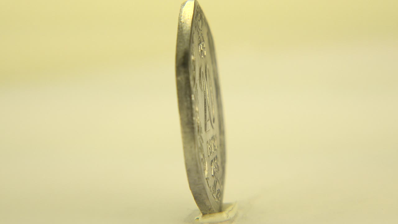 Coin upright on edge with blurred markings