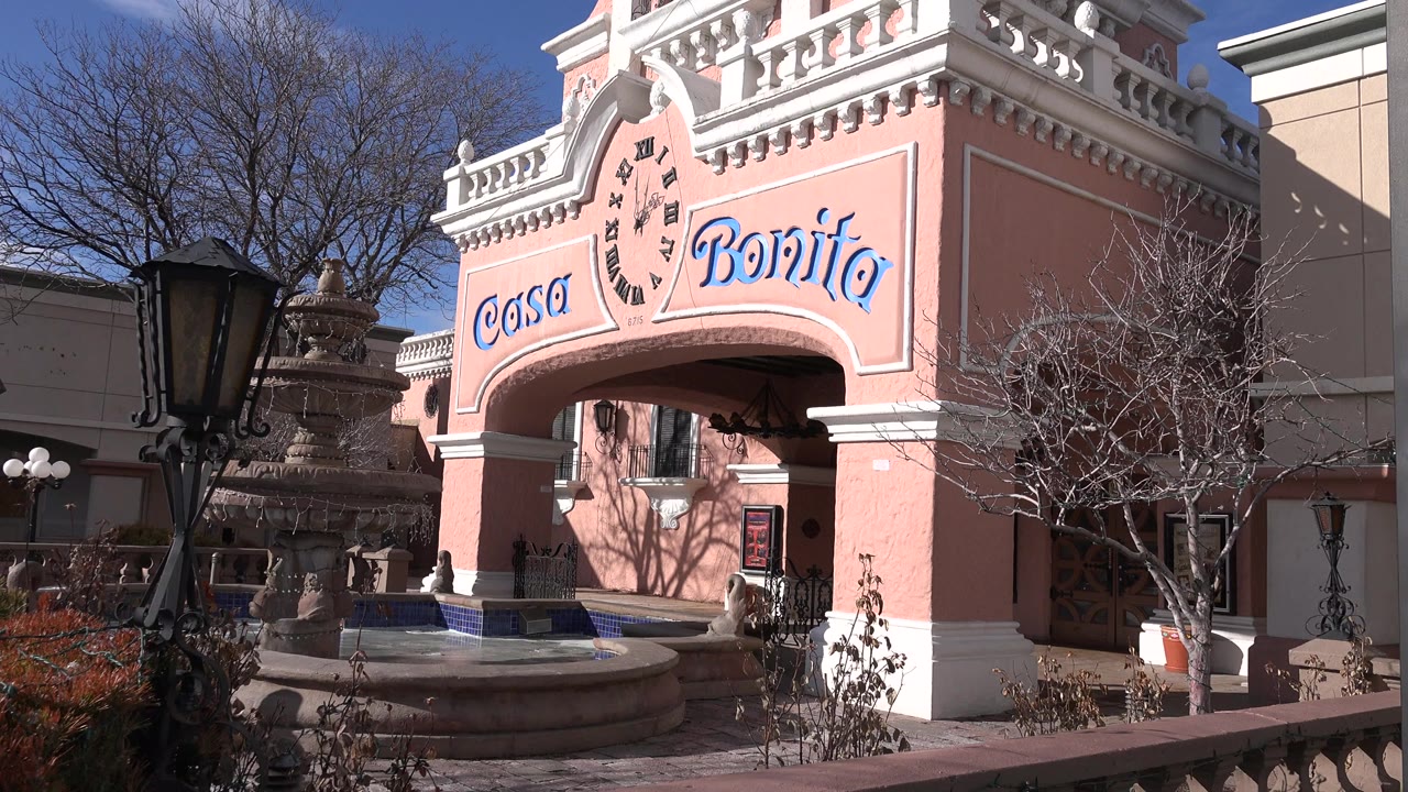 Pink Casa Bonita facade with fountain and lamp post