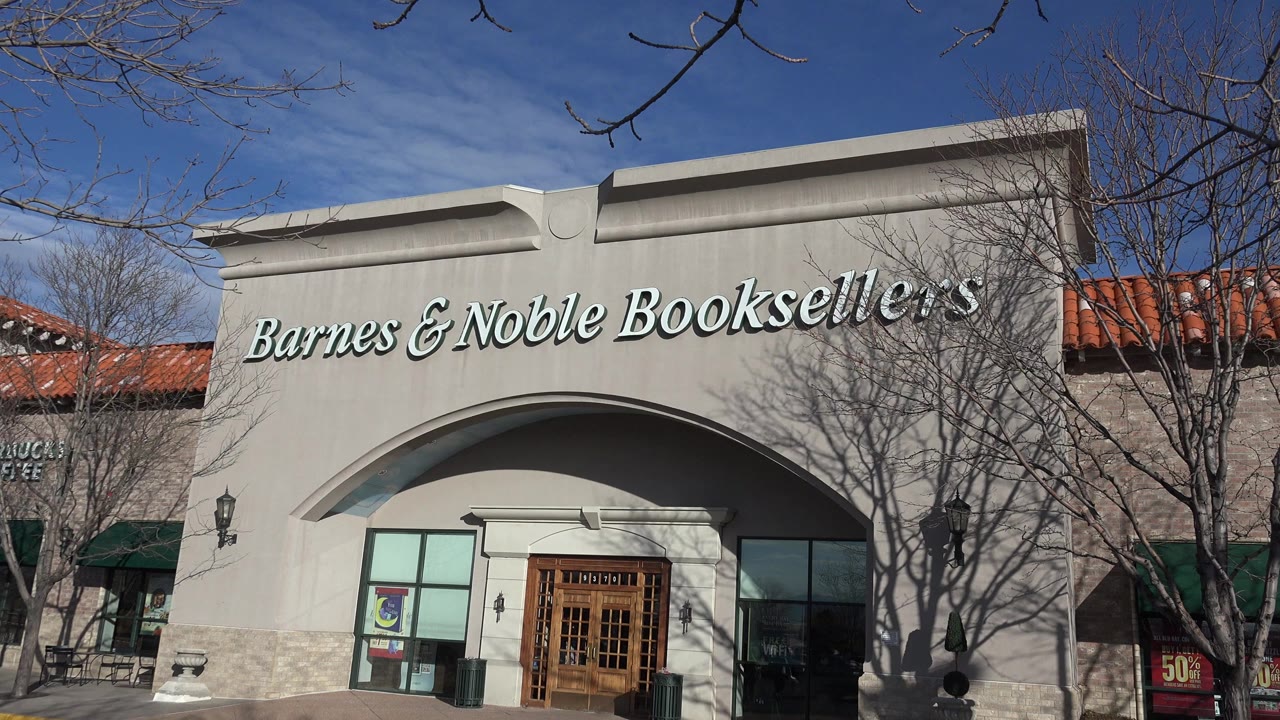 Barnes & Noble storefront with arched entrance and leafless trees