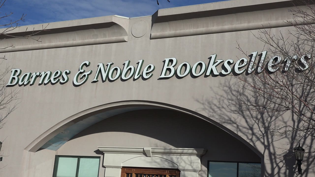 Barnes & Noble Booksellers sign above an arched storefront entrance.