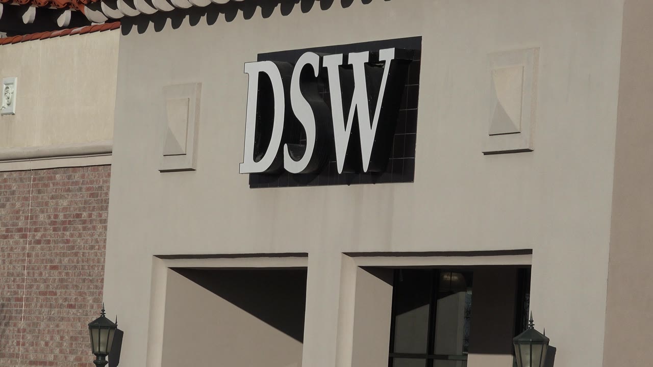 Close view of a DSW sign on a retail building facade.