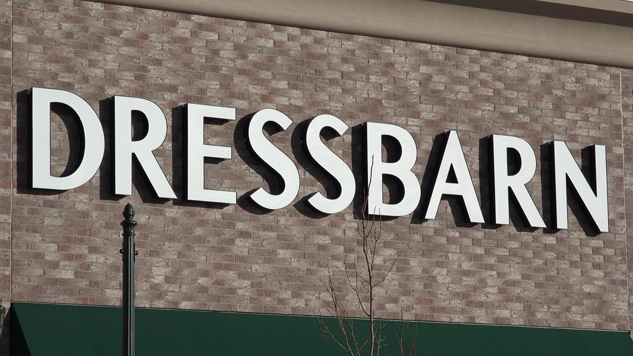 Close view of the Dressbarn sign on a brick storefront.