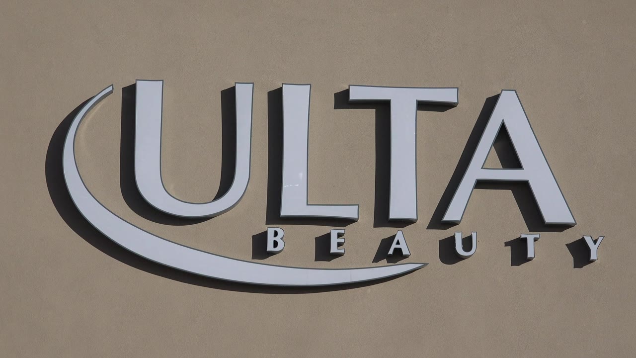 Close view of the Ulta Beauty sign on a tan storefront wall.