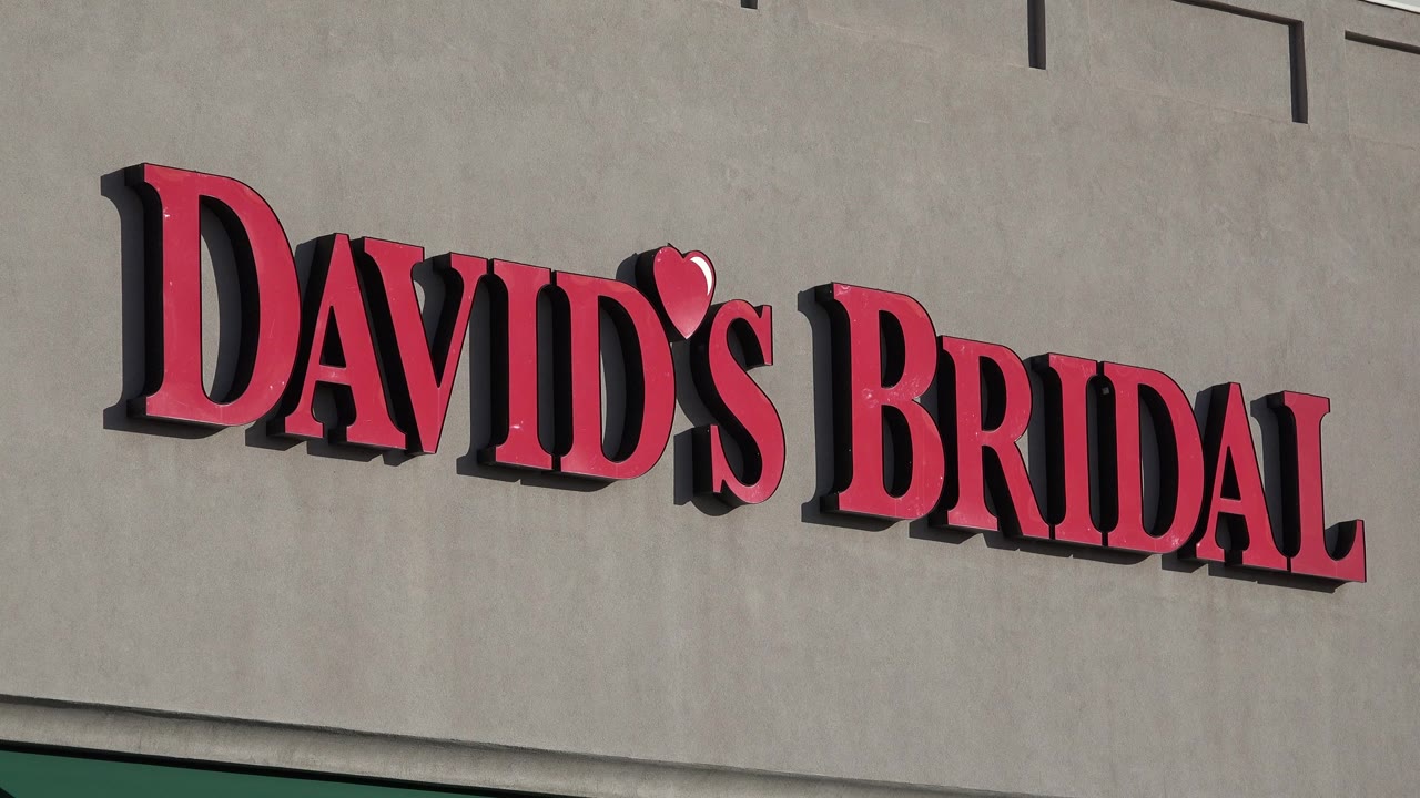 Tight Denver retail exterior view with the David's Bridal sign centered across the upper tan facade and no visible people.
