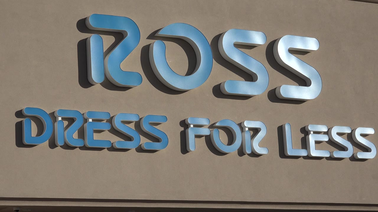 Tight Denver storefront frame showing the blue and white Ross Dress for Less sign on a tan stucco facade, with no visible people.