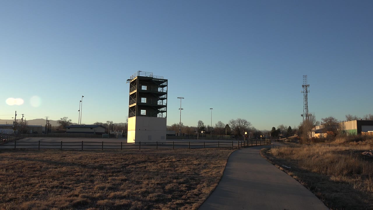Half-finished tower in dry field with path at right