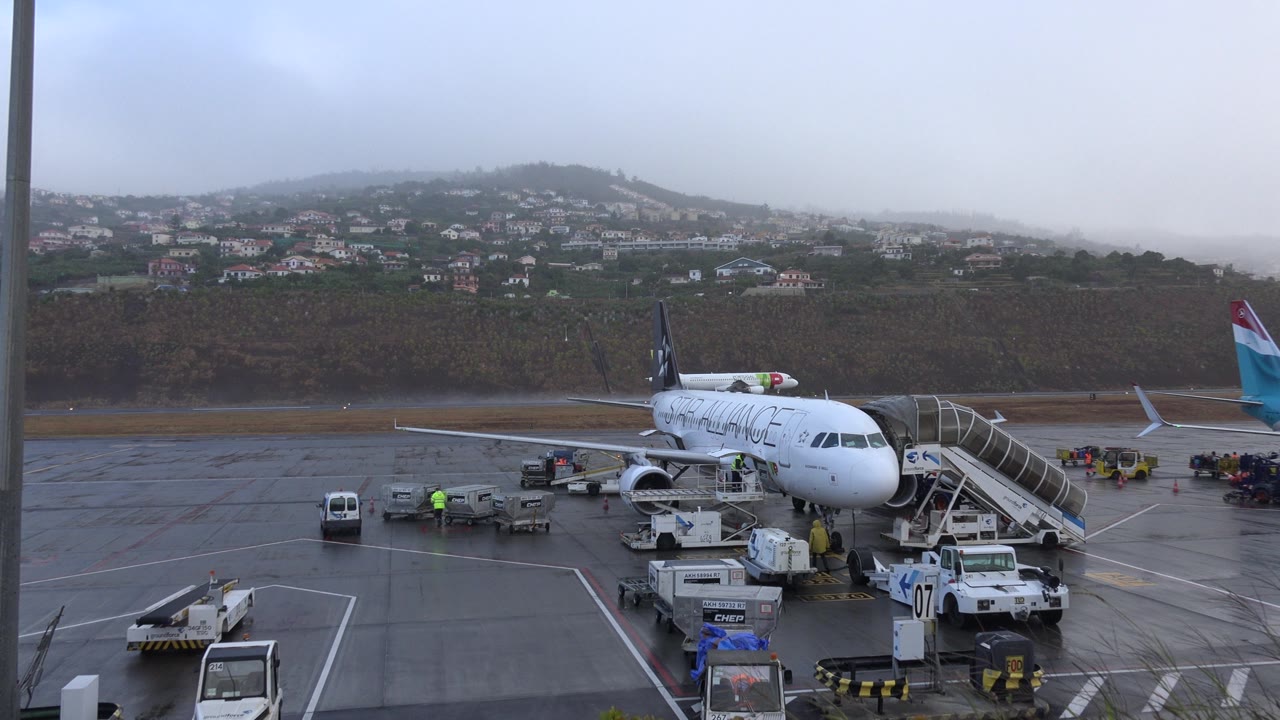 Parked aircraft with another plane in the background
