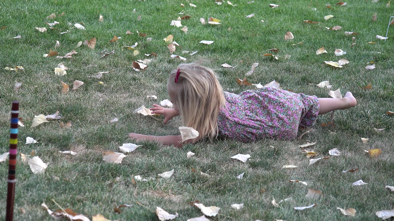 Young girl beginning to push up from the grass.
