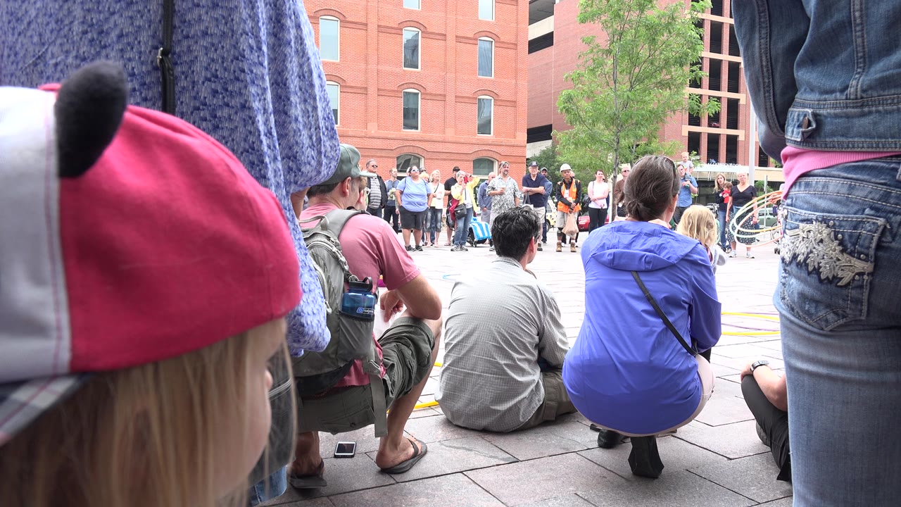 Street show crowd with a child cap filling the foreground.