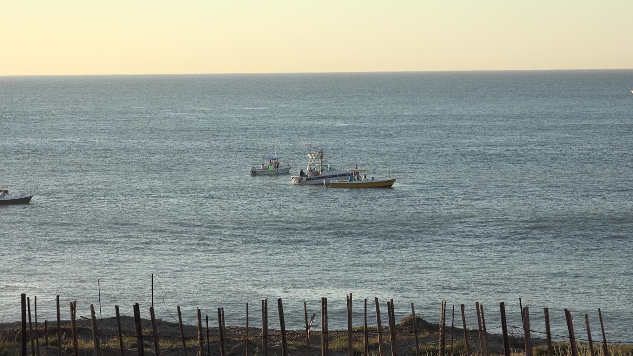 A small boat appears left of center while two larger distant boats sit farther back on the water in the Grand Junction, Colorado clip.