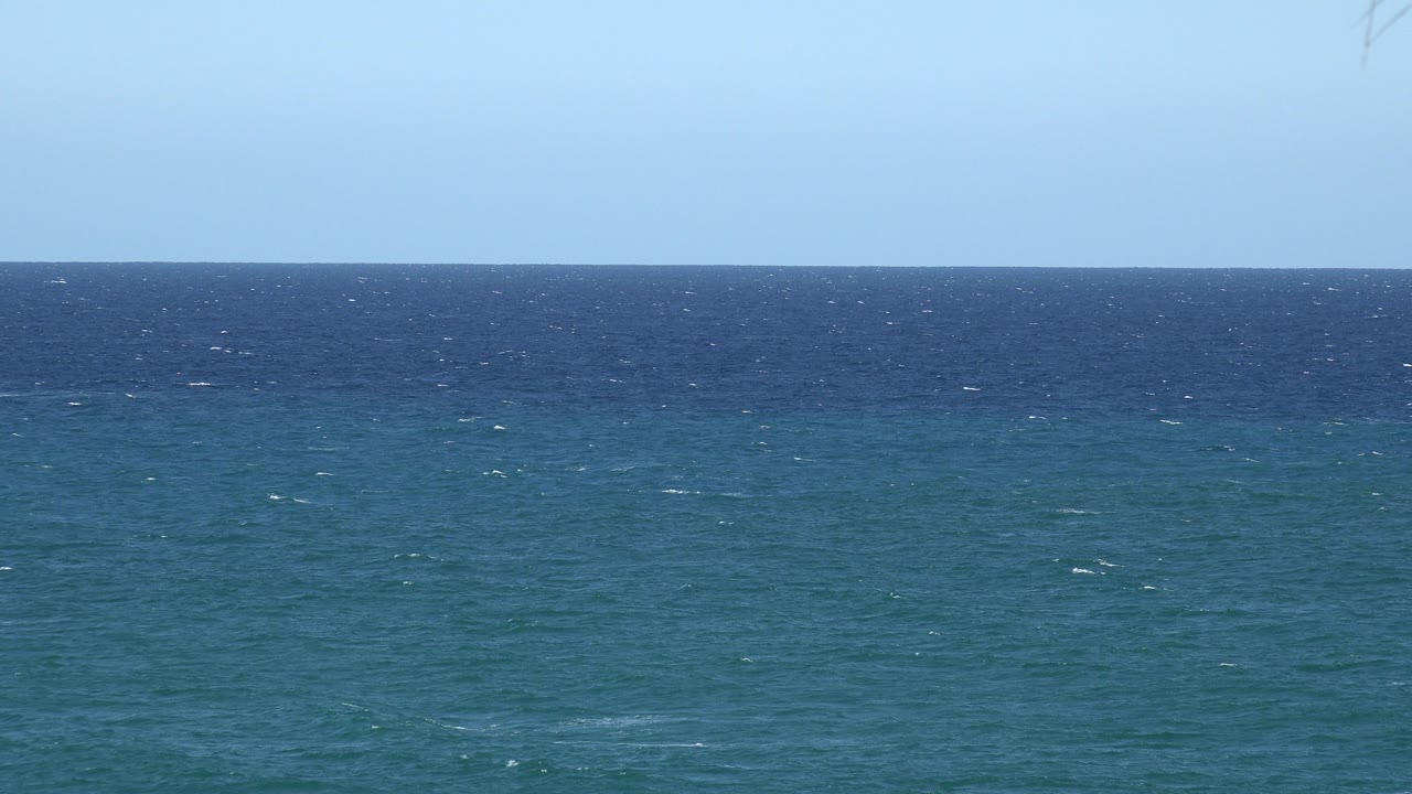 At one second, the Grand Junction Colorado 2017 frame holds on darker blue water near the horizon, lighter teal water below, clear sky above, and no visible people.