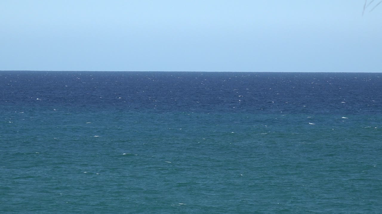 Opening frame of the Grand Junction, Colorado catalog clip showing blue-green sea, a darker horizon band, pale sky, and no visible people.